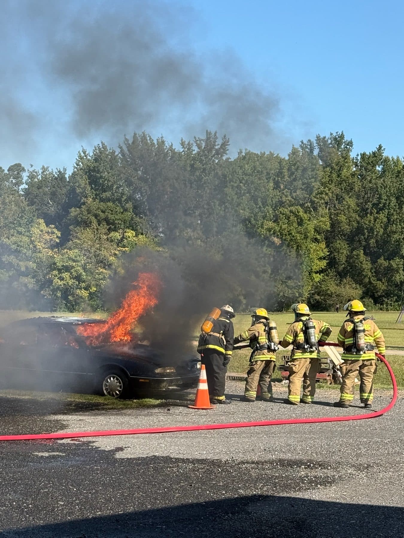 Garysburg Volunteer Fire Department firefighters working a hose line to extinguish a vehicle fire
